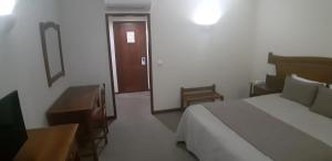 Cama ou camas em um quarto em Hotel Santa Maria
