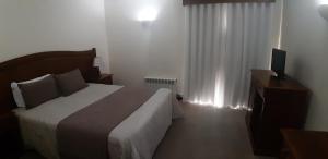 Cama ou camas em um quarto em Hotel Santa Maria