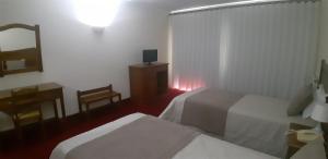 Cama ou camas em um quarto em Hotel Santa Maria