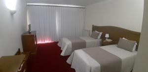 Cama ou camas em um quarto em Hotel Santa Maria
