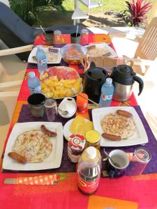 a picnic table with plates of food on it at Victoria Lake View Guesthouse & Safaris in Entebbe