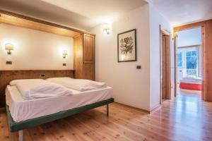 a hotel room with a bed and a desk at Sporting Clubresidence in San Martino di Castrozza