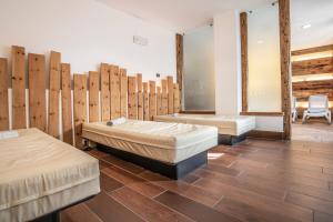 a bed room with a wooden floor and wooden walls at Sporting Clubresidence in San Martino di Castrozza