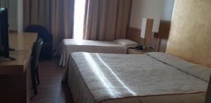 Posteľ alebo postele v izbe v ubytovaní Hotel Tiffany Milano