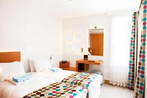 Postel nebo postele na pokoji v ubytování Sunpark Garden Hotel