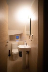 a bathroom with a white toilet and a sink at Athena Villa in Ayia Napa