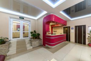 a lobby with a red counter in a building at Hotel Nivki in Kyiv