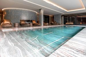 a swimming pool in a hotel room with a large pool at Vila Foz Hotel & SPA - member of Design Hotels in Porto