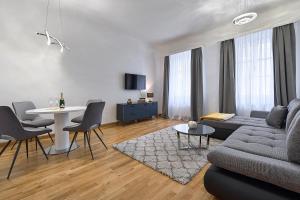 a living room with a couch and a table at Vienna City Apartments Krongasse in Vienna