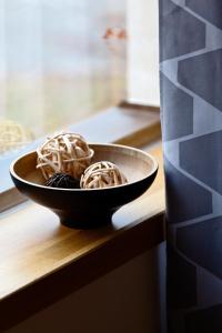 three donuts in a bowl on a table at Hotel Wolf in Prague