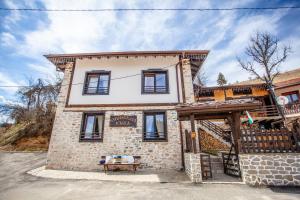 a house with a bench in front of it at Kutsinska House in Progled