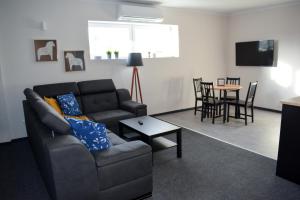 a living room with a couch and a table at APARTAMENTY VINCI in Krasnystaw