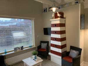 a living room with a large window and a lighthouse at Texelheerlijk 1 in De Koog