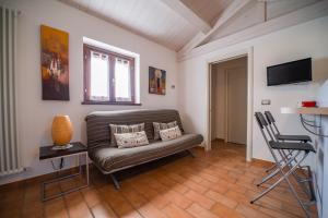 a living room with a couch and a television at Country House Ca' Brunello in Urbino