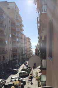 a view of a city street with parked cars at Poly's House in Torre Annunziata