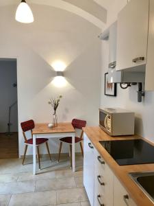 a kitchen with a small table and chairs in a kitchen at Apartments near Rathaus in Vienna