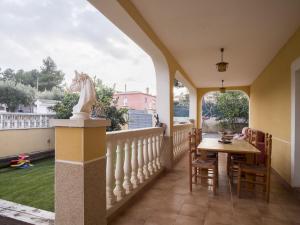 a balcony with a table and a horse statue at Belvilla by OYO Casa Crepuscle in El Vendrell