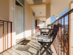 a balcony with a table and chairs on it at Bella Vista Premium Apartment in Poreč