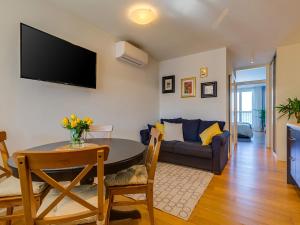 a living room with a table and a couch at Bella Vista Premium Apartment in Poreč