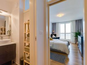 a bedroom with a bed and a bathroom with a sink at Bella Vista Premium Apartment in Poreč