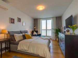 a bedroom with a large bed and a television at Bella Vista Premium Apartment in Poreč