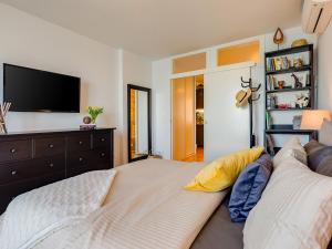 a living room with a couch and a flat screen tv at Bella Vista Premium Apartment in Poreč