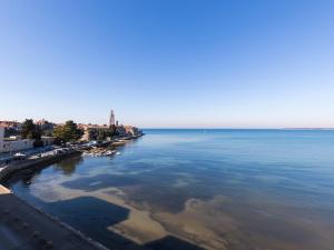 a large body of water with a beach and buildings at Bella Vista Premium Apartment in Poreč