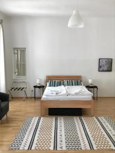 a bedroom with a bed and a rug on the floor at Apartments near Rathaus in Vienna