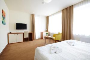 Postel nebo postele na pokoji v ubytování Hotel Radun