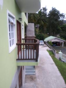 a balcony of a house with a car on the street at Hidden Gem Apartments (No.5) in Castries