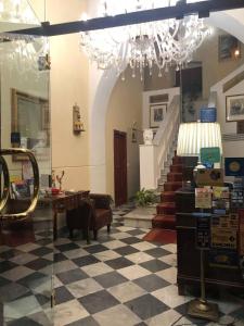 a room with a checkered floor and a chandelier at B&B Al Piazza Marina in Palermo