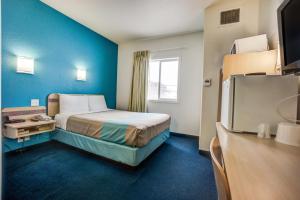 a hotel room with a bed and a television at Motel 6-Red Deer, AB in Red Deer