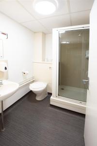 a bathroom with a shower and a toilet and a sink at Lancaster University in Lancaster