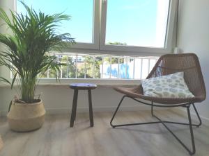 a room with a chair and a table and a plant at Cascais Family & Friends in Cascais
