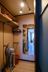 a room with a fan and a hallway at ОК! Никитина, 20 №1 in Tomsk