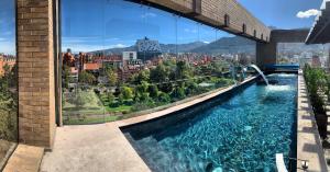 a swimming pool with a view of a city at Cassa Luxury Homes in Bogotá