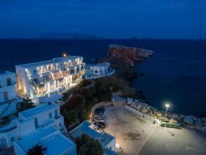 an aerial view of a building with the ocean at night at Vardia Bay Studios in Karavostasi