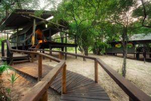 a wooden ramp leading up to a building with trees at Camp Bethel in Hoedspruit