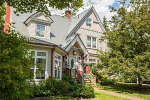 a large white house with a porch at The Harbour House in Charlottetown