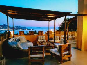 a patio with couches and a view of the ocean at Villa Cosy in Yalıkavak