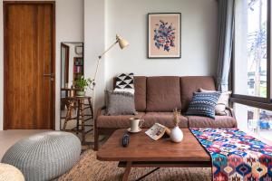 a living room with a couch and a table at APT476 in Bangkok