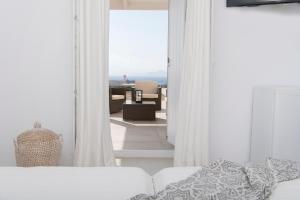 a white bedroom with a view of a living room at White Santa Maria Villa in Santa Maria