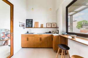 a kitchen with wooden cabinets and a window at APT476 in Bangkok