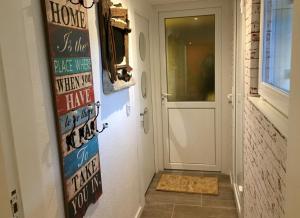 a hallway with a door with a sign that reads home is the place where when at Le Gîte de Brigitte ! in Saint Die +30 photos