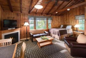 a living room with a bed and a fireplace at Hueston Woods Lodge and Conference Center in Oxford