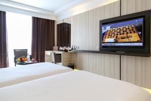a hotel room with a bed and a flat screen tv at Radisson Hotel Sfax in Sfax