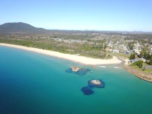 an aerial view of a beach and the ocean at Coastal Hideaway in South West Rocks