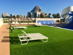 a rendering of a lawn with two benches on it at Sea View Apartment Arenal Beach Calpe in Calpe