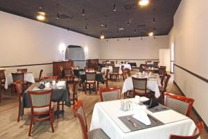 a dining room with white tables and chairs and a room with at Windward Passage Hotel in Charlotte Amalie