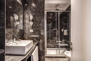 a bathroom with a sink and a shower at Hotel 55 Fifty-Five - Maison d'Art Collection in Rome +57 photos